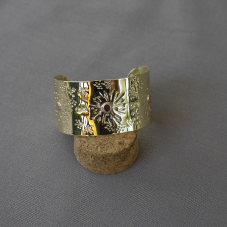 Bracelet manchette en laiton martelé 25 mm posé sur socle, trois rivets cuivre soudés à l’argent